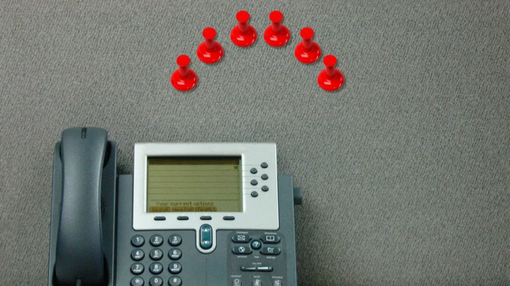 Office desk phone illustrating workplace strategy and office planning